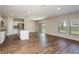 Inviting living area with wood floors, natural light, and seamless transition to the kitchen at 1768 Frogmore Ave, Haines City, FL 33844
