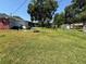 A backyard with a table, grill, and surrounding houses, offering a sense of community and outdoor living at 231 Connie Lee Ct, Lakeland, FL 33809