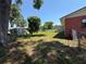 A spacious backyard with a shed, trees, and a partial view of the home's exterior at 231 Connie Lee Ct, Lakeland, FL 33809