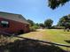 Spacious fenced backyard with a well-maintained lawn and mature trees, showing the property's exterior at 231 Connie Lee Ct, Lakeland, FL 33809