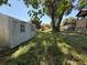 Wide backyard showing the shed with trees and surrounding homes, offering a sense of community at 231 Connie Lee Ct, Lakeland, FL 33809