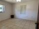 Bedroom with neutral tile floors, light-colored walls, ceiling fan, and bright natural lighting at 231 Connie Lee Ct, Lakeland, FL 33809