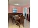 Traditional dining room with wooden table and chairs, neutral tile floors, and natural lighting at 231 Connie Lee Ct, Lakeland, FL 33809
