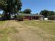 Charming brick home with a well-maintained lawn and a cozy front porch at 231 Connie Lee Ct, Lakeland, FL 33809