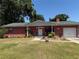 Charming single-story brick home with a well-maintained lawn and welcoming front porch at 231 Connie Lee Ct, Lakeland, FL 33809
