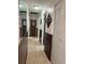Hallway with paneled walls, tile flooring, and doors leading to various rooms in the house at 231 Connie Lee Ct, Lakeland, FL 33809