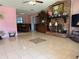 Spacious living room with decorative fireplace, neutral tile floors, and adjoined dining room at 231 Connie Lee Ct, Lakeland, FL 33809