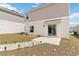 Backyard showcasing a patio, string lights, and a well-maintained lawn at 356 Loch Ct, Davenport, FL 33837