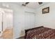 Cozy bedroom featuring a dark wooden bed frame, double closet, and neutral carpet at 356 Loch Ct, Davenport, FL 33837