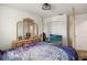 Bedroom featuring a four-poster bed, dresser with mirrors, and a ceiling fan at 356 Loch Ct, Davenport, FL 33837