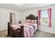 Charming bedroom with decorative headboard, neutral carpet, and window with bright natural light at 356 Loch Ct, Davenport, FL 33837