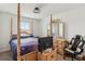 Bright bedroom with four-poster bed, light wood furniture, and overhead lighting at 356 Loch Ct, Davenport, FL 33837