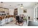 Bright dining area adjacent to the kitchen, featuring a chandelier and a table with seating for four at 356 Loch Ct, Davenport, FL 33837
