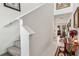 Bright hallway leading from the staircase to the living areas, decorated with artwork and rugs at 356 Loch Ct, Davenport, FL 33837