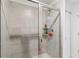 Tiled shower with glass door, built in shelf and brushed nickel hardware at 356 Loch Ct, Davenport, FL 33837