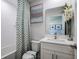Clean bathroom with tub, shower, and vanity featuring floral accents at 1022 Brimstone Cir, Winter Haven, FL 33884