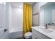 Bright bathroom featuring textured white tile, yellow shower curtain, white vanity, and framed artwork at 1022 Brimstone Cir, Winter Haven, FL 33884
