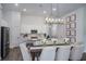 Elegant dining room with modern chandelier, adjacent to a kitchen with stainless steel appliances at 1022 Brimstone Cir, Winter Haven, FL 33884
