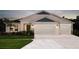 Charming single-Gathering home with a two-car garage, well-manicured lawn, and beautiful landscaping at 1022 Brimstone Cir, Winter Haven, FL 33884