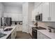 Bright, modern kitchen featuring quartz countertops, stainless steel appliances, and ample storage at 1022 Brimstone Cir, Winter Haven, FL 33884