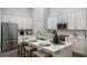 Modern kitchen with stainless steel appliances, a central island, and ample white cabinetry at 1022 Brimstone Cir, Winter Haven, FL 33884