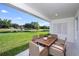 Inviting covered patio with comfortable seating and picturesque views of the pond at 1022 Brimstone Cir, Winter Haven, FL 33884