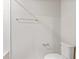 View of bathroom with white toilet, tiled shower and chrome towel racks at 1616 Ellesmere Ave, Haines City, FL 33844