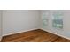This bedroom boasts wood floors and two windows with blinds, providing a bright and comfortable space at 1616 Ellesmere Ave, Haines City, FL 33844