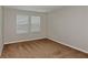 Bedroom with neutral walls, carpeting, and two windows with blinds at 1616 Ellesmere Ave, Haines City, FL 33844