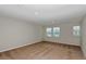 Spacious bedroom featuring neutral walls, carpeting, and three windows with blinds at 1616 Ellesmere Ave, Haines City, FL 33844