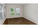 Bright bedroom with hardwood floors and multiple windows with lots of natural light at 1616 Ellesmere Ave, Haines City, FL 33844
