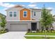 Charming two-story home featuring a landscaped yard, integral garage, and welcoming entrance at 1616 Ellesmere Ave, Haines City, FL 33844