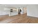 Open kitchen with white cabinets, stainless steel appliances, island and hardwood floors at 1616 Ellesmere Ave, Haines City, FL 33844