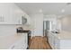Bright kitchen featuring white cabinets, stainless steel appliances, and hardwood floors at 1616 Ellesmere Ave, Haines City, FL 33844