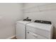 This laundry room has a washer, dryer, and upper cabinet storage for added convenience at 1616 Ellesmere Ave, Haines City, FL 33844