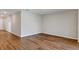 Open Living Room with hardwood floors, base molding and neutral paint color at 1616 Ellesmere Ave, Haines City, FL 33844