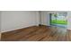 Open living room featuring hardwood floors and glass sliding doors to the backyard at 1616 Ellesmere Ave, Haines City, FL 33844