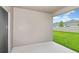 A covered patio overlooks a well-manicured lawn and fenced backyard, offering an ideal space for outdoor enjoyment at 1616 Ellesmere Ave, Haines City, FL 33844