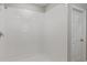 This bathroom features a bright, clean, tiled shower and a door to the rest of the house at 1616 Ellesmere Ave, Haines City, FL 33844