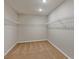 Spacious walk-in closet featuring carpet, built-in wire shelving, and ample storage for organization at 1616 Ellesmere Ave, Haines City, FL 33844