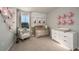 Charming Bedroom featuring a crib, dresser, and soft decor accents at 2004 Marigold Aly, Winter Haven, FL 33884