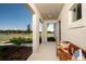 Inviting front porch features stylish bench seating, manicured landscaping and open views at 2004 Marigold Aly, Winter Haven, FL 33884