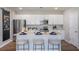Modern kitchen with stainless steel appliances, white cabinetry, and a large center island at 2004 Marigold Aly, Winter Haven, FL 33884