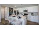 Bright kitchen featuring a large center island with seating and stainless steel appliances at 2004 Marigold Aly, Winter Haven, FL 33884
