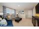 Cozy living room featuring a comfortable sofa and large windows at 2004 Marigold Aly, Winter Haven, FL 33884