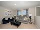 Comfortable living room featuring a gray sofa and wall decorations at 2004 Marigold Aly, Winter Haven, FL 33884