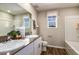 Neutral bathroom with a double sink vanity, dark wood floor, patterned window shade and a shower at 2212 Canyon Oak Dr, Davenport, FL 33837