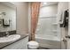 Clean bathroom with shower-tub combination, neutral color scheme, and functional design at 2212 Canyon Oak Dr, Davenport, FL 33837