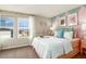 Well-lit bedroom featuring playful decor, large windows and an inviting, comfortable queen-sized bed at 2212 Canyon Oak Dr, Davenport, FL 33837