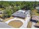Aerial view of brick home with pool, two-car garage, and circular driveway at 930 29Th Nw St, Winter Haven, FL 33881